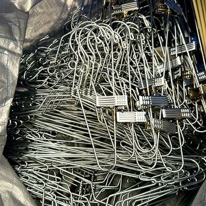Metal hangers with and without pant clips… 3 huge bags full value $3,000